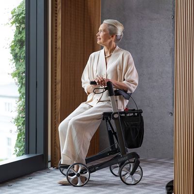 Lady seated on a rollator walker
